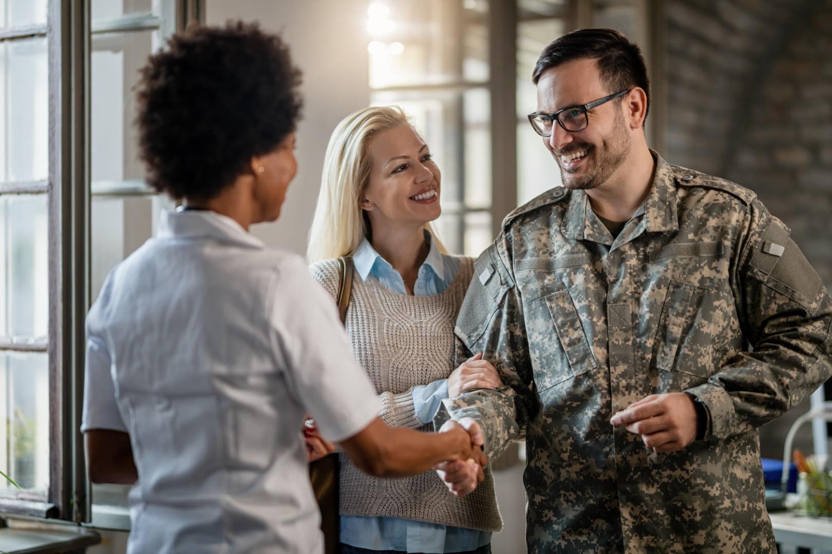 Happy,Military,Man,Shaking,Hands,With,Female,Doctor,While,Being