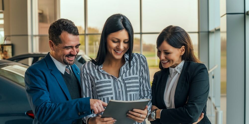 car-dealer-showing-contract-his-customers